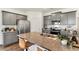 Modern kitchen featuring gray cabinets, stainless steel appliances, and a granite-topped island with seating at 4692 Hatcher Dr, Brighton, CO 80601