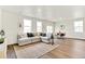 Spacious living area with a plush sectional sofa, hardwood floors, and lots of natural light at 4692 Hatcher Dr, Brighton, CO 80601