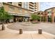 Building entrance featuring beautiful landscaping and fountain at 5455 Landmark Pl # 1103, Greenwood Village, CO 80111