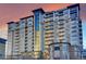 Modern high-rise condominium building with many balconies at sunset at 5455 Landmark Pl # 1103, Greenwood Village, CO 80111