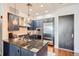Modern kitchen with blue cabinets, stainless steel appliances, and granite countertops at 5455 Landmark Pl # 1103, Greenwood Village, CO 80111