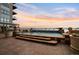 A stunning outdoor pool and hot tub area with sunset views and comfortable lounge seating at 5455 Landmark Pl # 1103, Greenwood Village, CO 80111