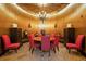 A unique wine room with a round table, red chairs, and ambient lighting for an exquisite tasting experience at 5455 Landmark Pl # 1103, Greenwood Village, CO 80111