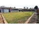 Large backyard featuring a well-maintained lawn, garden beds, a shed, and a pergola-covered patio at 4833 S Elati St, Englewood, CO 80110