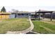 Spacious backyard with lush lawn, garden beds, shed, patio, and pergola perfect for outdoor living at 4833 S Elati St, Englewood, CO 80110