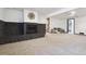 Basement space with stone fireplace, carpeted floor, and modern lighting, ideal for recreation and entertainment at 4833 S Elati St, Englewood, CO 80110