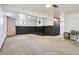 Spacious basement with a fireplace, patterned curtains, and neutral carpet offers potential for various uses at 4833 S Elati St, Englewood, CO 80110