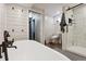 Bright bathroom featuring shiplap walls, soaking tub, a glass shower, and modern fixtures for a spa-like feel at 4833 S Elati St, Englewood, CO 80110