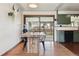 Rustic dining area with a custom wood table, connected to a sunroom with access to outdoor living at 4833 S Elati St, Englewood, CO 80110