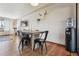 Dining area showcases a rustic wooden table and seating, open to the living room with ample natural light at 4833 S Elati St, Englewood, CO 80110