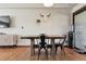Dining space features a rustic wooden table, modern black chairs, and minimalist decor, perfect for Gathering meals at 4833 S Elati St, Englewood, CO 80110