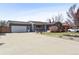 Well-maintained home featuring a landscaped front yard, garage, large driveway, and appealing curb appeal at 4833 S Elati St, Englewood, CO 80110