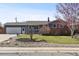 Charming single-Gathering home featuring a well-manicured lawn and mature landscaping adding to its curb appeal at 4833 S Elati St, Englewood, CO 80110
