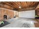 Spacious garage with exposed wooden beams and ample storage, ready for parking and projects at 4833 S Elati St, Englewood, CO 80110