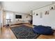 Open-concept living room with hardwood floors and stylish decor, adjacent to the dining area and kitchen at 4833 S Elati St, Englewood, CO 80110