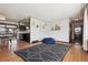 Spacious living area showcasing hardwood floors and an open transition to the kitchen and dining area at 4833 S Elati St, Englewood, CO 80110