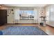 Living room bathed in natural light, showcasing hardwood floors, a spacious layout, and a view of the outdoors at 4833 S Elati St, Englewood, CO 80110