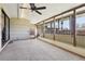 Spacious sunroom with exposed beams, multiple windows, and a neutral palette offers a bright and airy atmosphere at 4833 S Elati St, Englewood, CO 80110