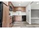 Well-designed kitchen with wood cabinets, stainless steel appliances, and stone backsplash at 1182 Clermont St # 201, Denver, CO 80220