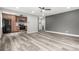 Open-concept living room featuring updated flooring and a ceiling fan at 1182 Clermont St # 201, Denver, CO 80220
