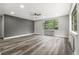 Open and airy living space with modern flooring, bright window, and ceiling fan at 1182 Clermont St # 201, Denver, CO 80220