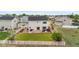 Aerial view of fenced backyard and back of home shows large patio with outdoor seating at 601 Morrison Dr, Frederick, CO 80530
