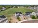 Aerial view of homes shows the large, grassy field behind, and solar panels on the roof at 601 Morrison Dr, Frederick, CO 80530