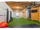 Basement gym with astroturf flooring, exposed ductwork, and unfinished ceiling provides an industrial feel at 601 Morrison Dr, Frederick, CO 80530