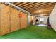 Basement workout area with astroturf, weights, unfinished walls and ceilings offers space to customize at 601 Morrison Dr, Frederick, CO 80530