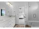 Bright bathroom with double vanity, large mirror, and glass-enclosed shower at 601 Morrison Dr, Frederick, CO 80530
