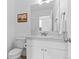 Clean, white half bathroom with a vanity, toilet, and mirror, offering a functional space at 601 Morrison Dr, Frederick, CO 80530