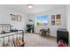 Well-lit bedroom with a view of the neighborhood and space for both sleeping and play at 601 Morrison Dr, Frederick, CO 80530
