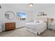 Neutral bedroom with a queen sized bed, light coming from a bright window, and simple decor at 601 Morrison Dr, Frederick, CO 80530