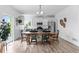 An open-concept dining room features a large wooden table and chairs next to an all-white kitchen at 601 Morrison Dr, Frederick, CO 80530