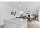 A kitchen island looks out onto a dining room with a fireplace and a staircase at 601 Morrison Dr, Frederick, CO 80530