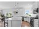 A bright kitchen features an island with white countertops, stainless steel appliances, and a subway tile backsplash at 601 Morrison Dr, Frederick, CO 80530