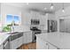 A bright, all-white kitchen features stone countertops, stainless steel appliances, and white subway tile at 601 Morrison Dr, Frederick, CO 80530