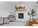 Bright living room with large windows, fireplace, hardwood floors, and stylish furniture at 601 Morrison Dr, Frederick, CO 80530