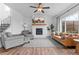 Bright living room with large windows, fireplace, hardwood floors, and stylish furniture at 601 Morrison Dr, Frederick, CO 80530