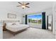 A well-lit main bedroom is spacious with large windows, a ceiling fan, and bright floors at 601 Morrison Dr, Frederick, CO 80530