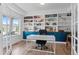 Well-lit home office with custom built-ins, a modern desk, and ample storage and display space at 601 Morrison Dr, Frederick, CO 80530