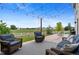 Cozy outdoor patio with comfortable seating, string lights, and views of the expansive backyard and field at 601 Morrison Dr, Frederick, CO 80530