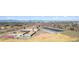Aerial view of a school, solar panels, recreation fields, and the cityscape at 7373 E Iowa Ave # 1108, Denver, CO 80231