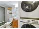 Basement bathroom with new appliances and stacked laundry units at 7373 E Iowa Ave # 1108, Denver, CO 80231