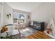 Sunlit Bedroom with a crib, a toddler bed, hardwood floors, and a large window at 7373 E Iowa Ave # 1108, Denver, CO 80231