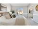 Bright bedroom featuring a large window, comfortable bedding, and stylish decor at 7373 E Iowa Ave # 1108, Denver, CO 80231