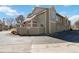 Townhome exterior with fenced patio, mature landscaping, and assigned parking spaces at 7373 E Iowa Ave # 1108, Denver, CO 80231