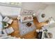 Aerial view of a bright living room with hardwood floors, a fireplace, and stylish furniture at 7373 E Iowa Ave # 1108, Denver, CO 80231