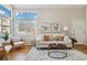 Bright living room features large windows, neutral tones, and hardwood floors at 7373 E Iowa Ave # 1108, Denver, CO 80231