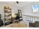 Loft-style office space with desk, shelving, and ample natural light from the skylight at 7373 E Iowa Ave # 1108, Denver, CO 80231